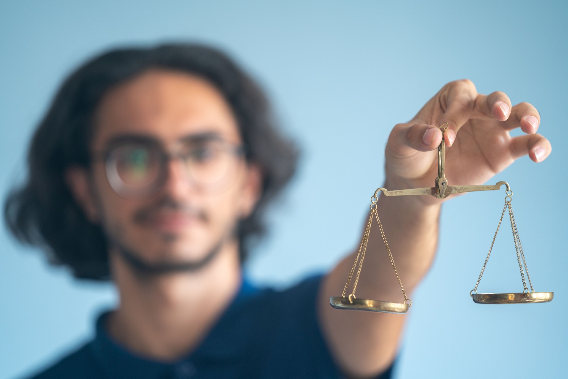 Portrait Of Young Man Holding Scales Of Justice